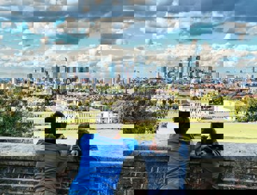 Two people looking out over the view of Greenwich and London