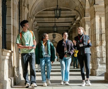 Four people taking tour of university campus.