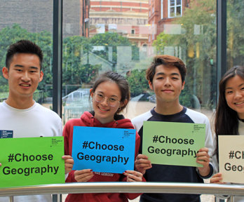 Four young people holding up signs with the text Choose Geography.
