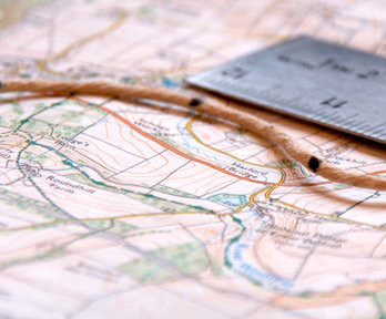Map, ruler and string close-up.