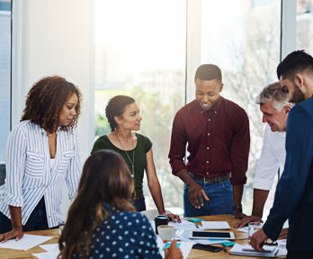 People talking around a table in an office.