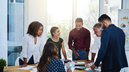 People talking around a table in an office.